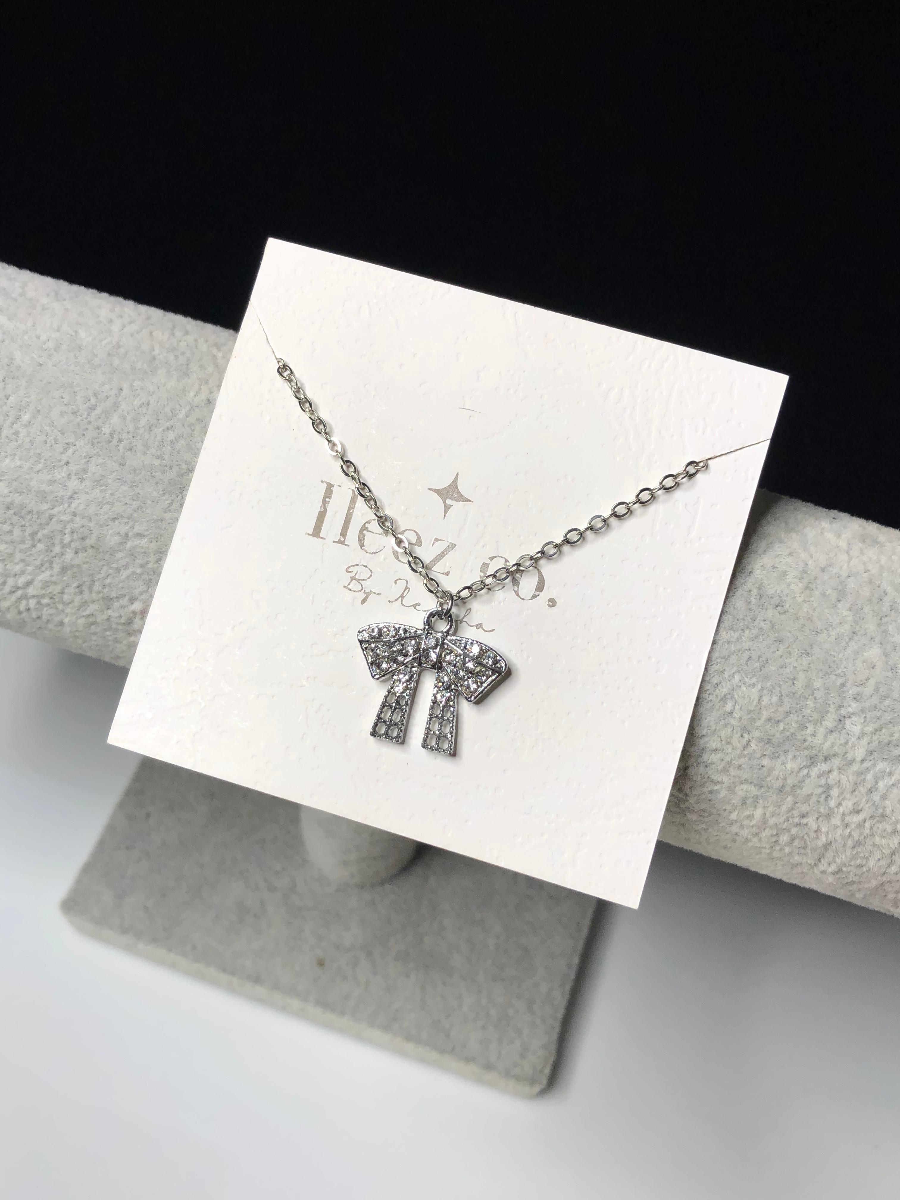 Silver bow charm necklace